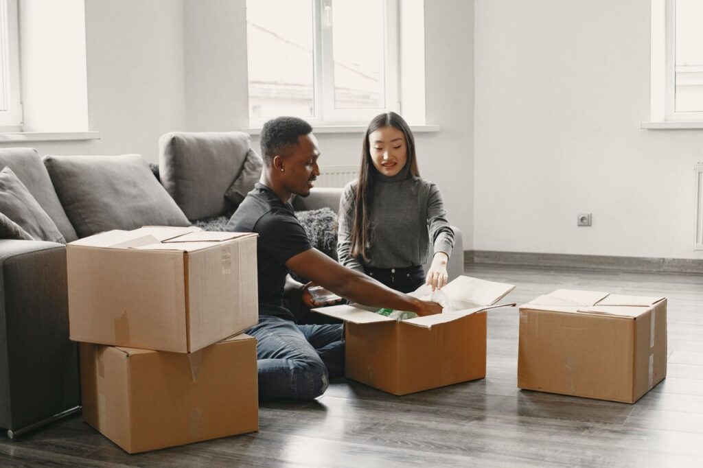 Relaxed couple surrounded by boxes after a smooth move