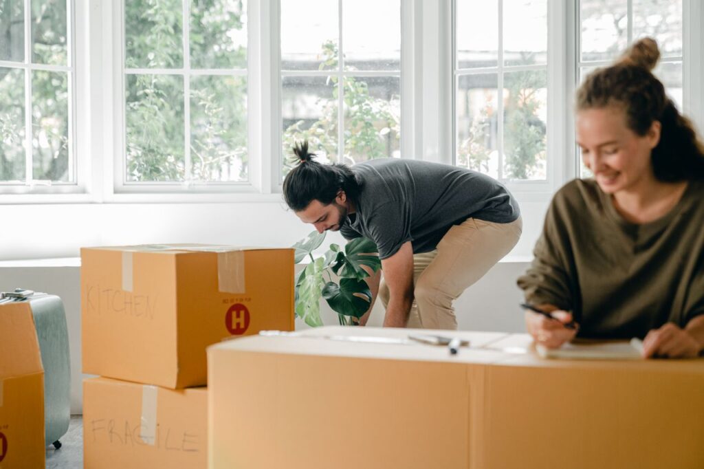 Couple standing among moving boxes in their new Orange County home