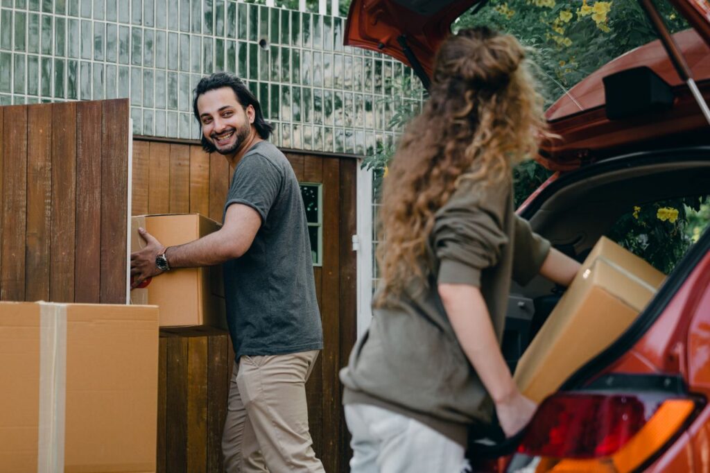 Couple unloading their car after moving to a new city