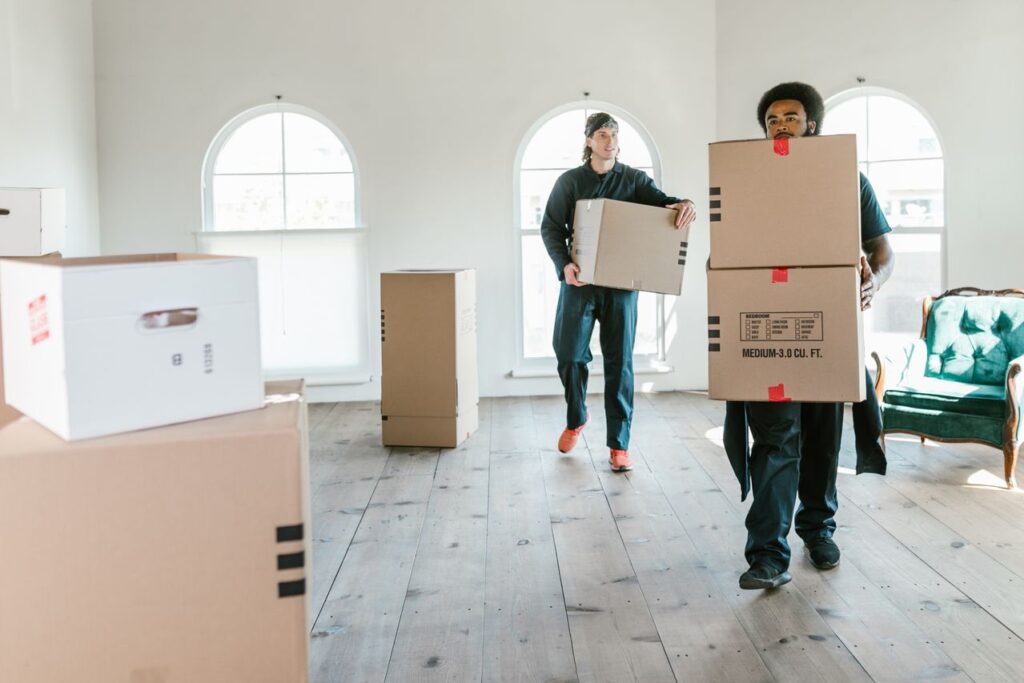 Professional movers carrying boxes for a client