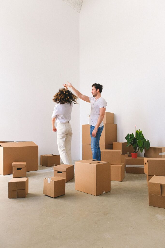 Relaxed couple enjoying their new home amid moving boxes